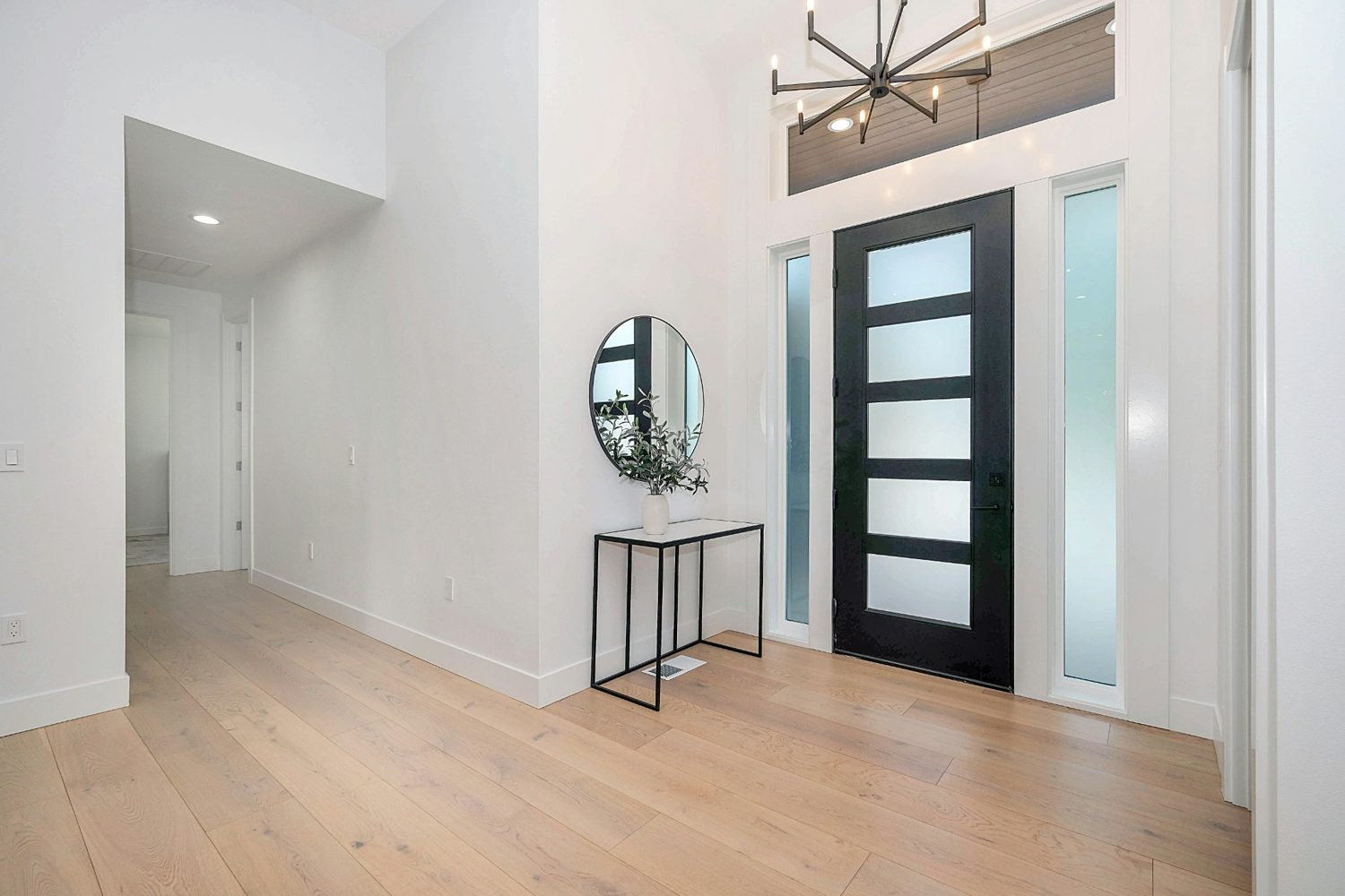 A bright front entry door inside a modern home